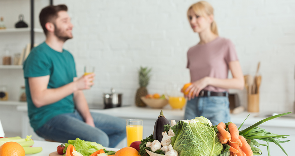 couple in kitchen with detox cleansing drink